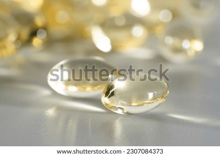 Fish Oil Omega 3 on white background, vitamin D yellow supplement gel capsules, macro shot Royalty-Free Stock Photo #2307084373