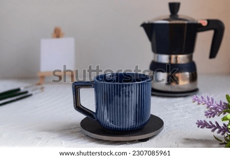 Small easel and mug with espresso coffee