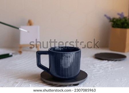 Small easel and mug with espresso coffee