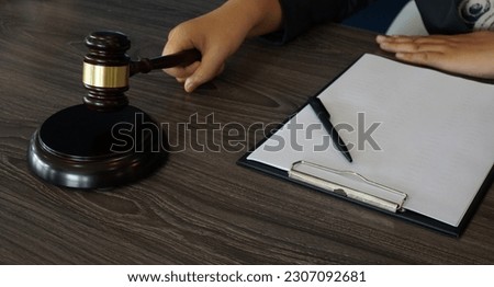 Legal counsel presents to the client a signed contract with gavel and legal law. Justice and lawyer law of advisor Concepts
