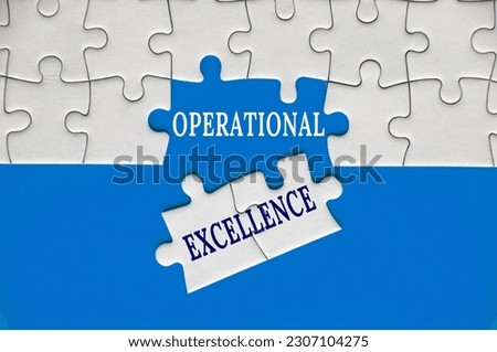 Operational Excellence text on missing jigsaw puzzle with blue cover background. Operational excellence concept Royalty-Free Stock Photo #2307104275