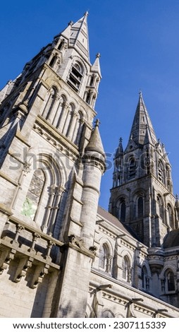 The tall Gothic spire of an Anglican church in Cork, Ireland. Neo-Gothic Christian architecture. Cathedral Church of St Fin Barre, Cork - One of Ireland’s Iconic Buildings. Royalty-Free Stock Photo #2307115339