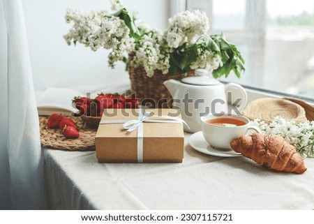 Gift box with a bow and holiday breakfast, surprise, good morning.