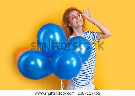 party girl with balloon in sunglasses. cheerful girl hold party balloons in studio.