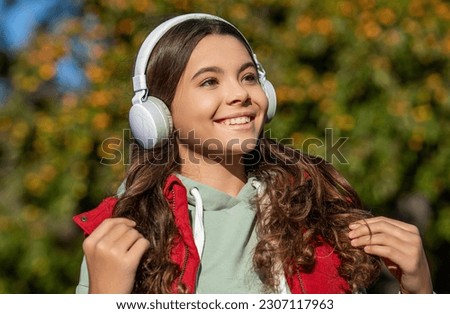 teen girl listening music wearing headphones. photo of teen girl listening music.