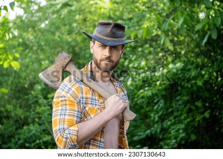 rancher with axe outdoor, copy space. photo of rancher with axe. rancher with axe.