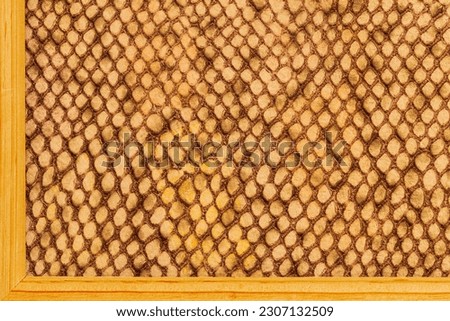 Genuine leather texture in wooden frame, bright color, trendy background. Concept of shopping, manufacturing
