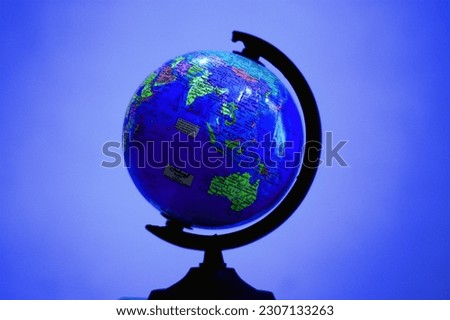 A globe is a three-dimensional scale model of the Earth or other round body. Because it is spherical, or ball-shaped, it can represent surface features, directions, and distances more accurately than 