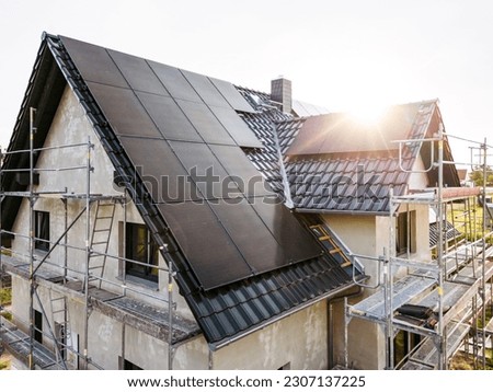 Construction site of a sustainable single family house with solar panels Royalty-Free Stock Photo #2307137225