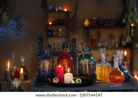 magic potions in  witch's house with burning candles at night Royalty-Free Stock Photo #2307144147