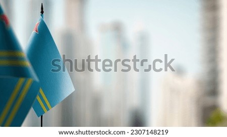 Small flags of the Aruba on an abstract blurry background.