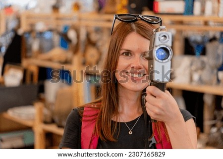 Retro camera. A woman takes pictures on a retro camera.