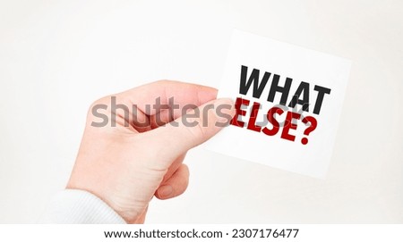 Businessman holding a card with text WHAT ELSE business concept