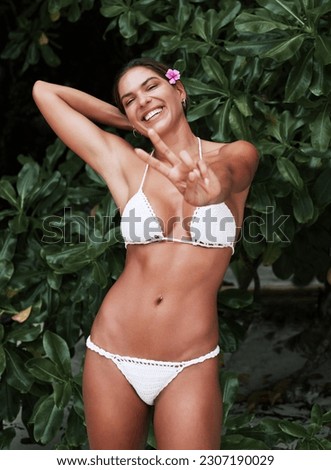 Young woman, bikini body and peace hand sign with happiness by a jungle and forest. Tropical, female person and happy smile with emoji hands gesture on a summer holiday feeling relax on vacation