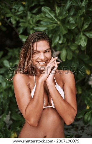 Happy woman, portrait and smile in bikini on island for travel, fun and freedom against a tree background. Swimwear, face and female model posing with confidence, joy and jungle aesthetic in nature