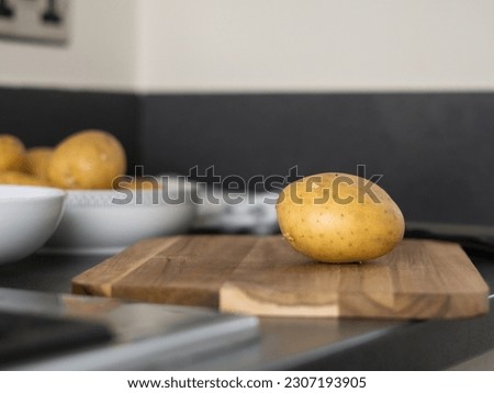 raw potatoes with peeled skin on the wooden desk on the table. High quality photo