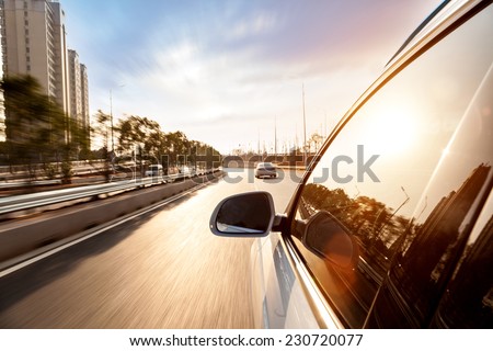 Car ride on road in sunny weather, motion blur  Royalty-Free Stock Photo #230720077