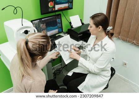 Consultation with optometrist with optical coherence tomography OCT scan to create pictures of the back of eye. Examination of eyes of patient using optical coherence tomograph
