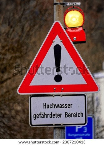Warning sign for a flood prone area with warning light