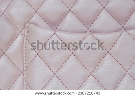 close up of pink leather bag detail with stitching