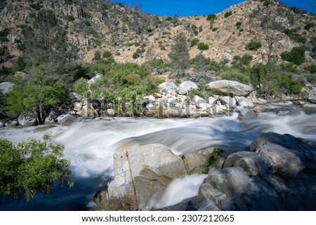 Long exposure California Spring runoff snowpack melt fast flooding river, rapids, cascading waterfall. Kern River