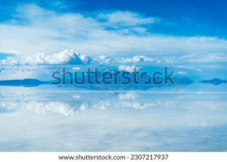 Uyuni Salt Flats. Altiplano, Bolivia. Rainy Season. Tunupa Volcano. Clouds Reflection on Water in Lake Surface. Royalty-Free Stock Photo #2307217937