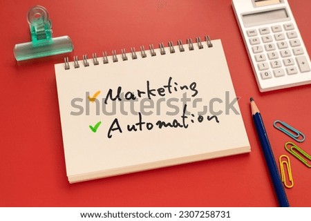 There is notebook with the word Marketing Automation.It is as an eye-catching image.