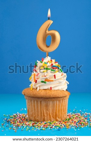 Birthday cake with candle number 6 - Blue background