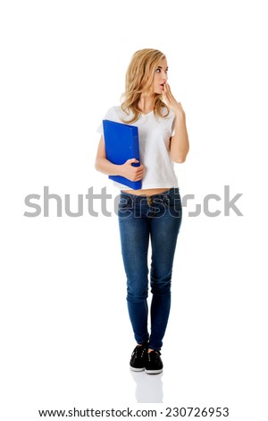 Surprised woman looking right, holding binder.