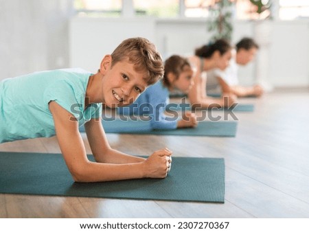 Family with exercising during yoga class at gym