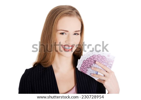 Businesswoman holding a clip of dollars.