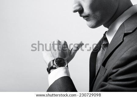 Business man checking time on his wrist watch