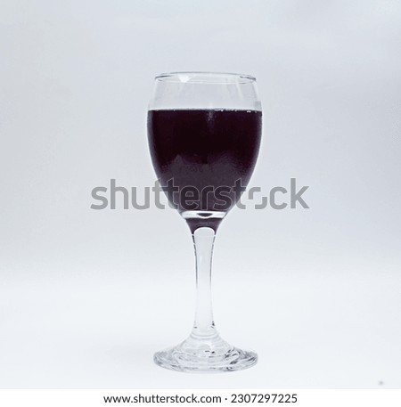 Purple grape wine in glass isolated white background