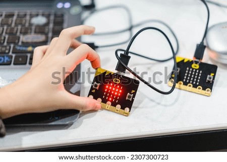 Primary school students play with Microbit and the block code in the background in the computer lab. Technology school Micro bit with coding.stem education.Creative.Robotic Ai. Coding. Learning. Royalty-Free Stock Photo #2307300723