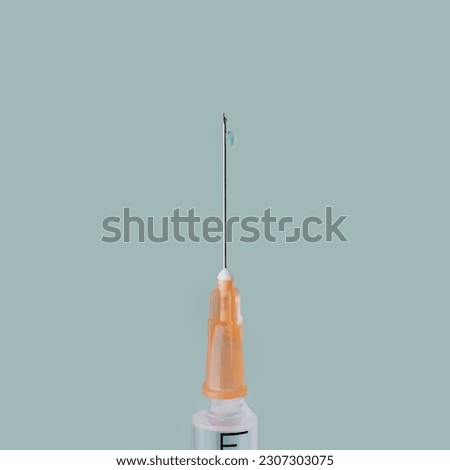 a syringe on a gray background