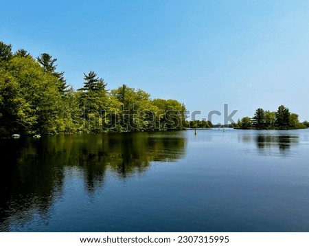 Springtime reflections in a Muskoka Lake, Canada Royalty-Free Stock Photo #2307315995
