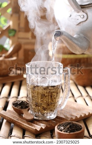 Tea is an aromatic beverage prepared by pouring hot or boiling water over cured or fresh leaves of Camellia sinensis, an evergreen shrub native to East Asia which probably originated in the borderland