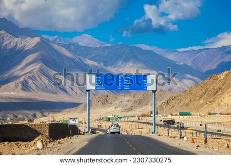 Road to Lamayuru, Ladakh city in India.Urban landscape with mountain background.Tourist in car with traffic sign.Blue sky with cloud.Landscape of Asia.