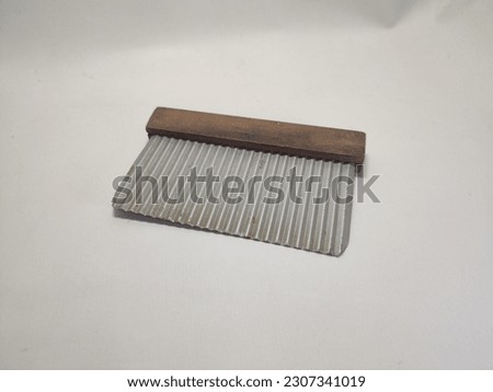Selective Focus is bright  a Traditional cutting tool, made of zinc and wood, usually, this tool is intended for cutting potatoes, carrots, or other materials, which are not so hard, 