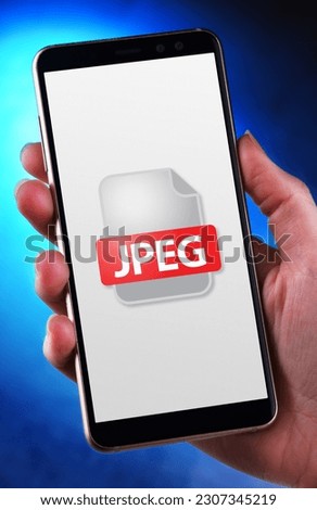 A smartphone displaying the icon of JPEG file Royalty-Free Stock Photo #2307345219