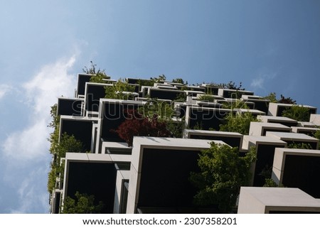 Sustainable and eco-friendly modern apartment building with balconies covered with trees in The Netherlands. Royalty-Free Stock Photo #2307358201
