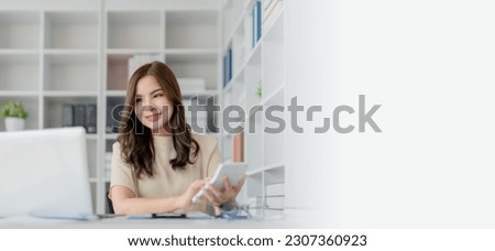 Beautiful young teen asian businesswoman  using computer laptop and calculator for calculate with planning working on financial document, tax, exchange, accounting and Financial advisor.