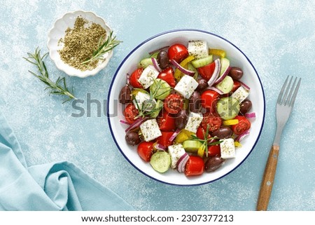 Greek salad. Vegetable salad with feta cheese, tomato, olives, cucumber, red onion and olive oil. Healthy vegetarian mediterranean diet food. Top view
