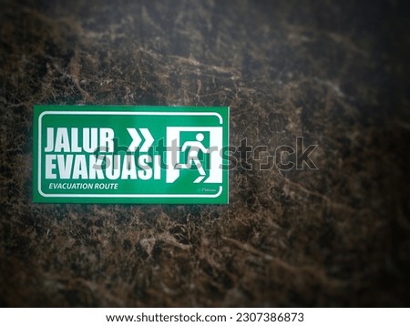 "Evacuation route" directional label on the wall