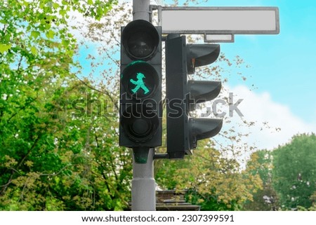 The little green man with hat on traffic lights in the former East Germany (Ampelmannchen) Royalty-Free Stock Photo #2307399591