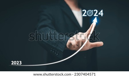 2024 Business Planning, Strategy, creative, idea concept. Businessman pointing chart graph with 2024 business icon, new setting goal, objective, target, goal, new year's resolution, business marketing Royalty-Free Stock Photo #2307404571