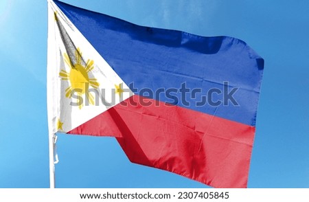 Philippines flag in cloudy sky. waving in the sky