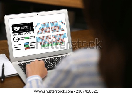 Woman buying theater tickets online via laptop at table, closeup Royalty-Free Stock Photo #2307410521