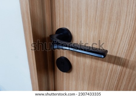 Timber door with black door handle, simple and elegant