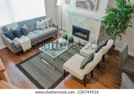 Luxury modern living suite, room with sofa and chairs and nicely decorated with vase coffee table. View from above. Interior design of a brand new house.